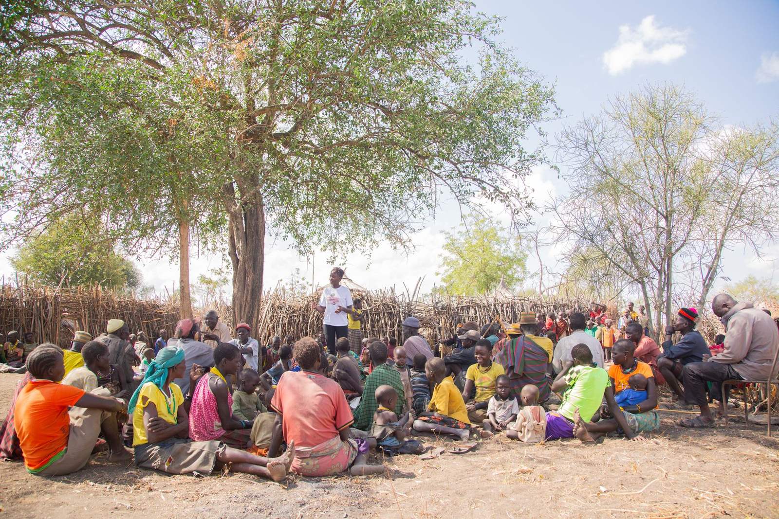 Company representatives meeting members of a farming community at a village gathering