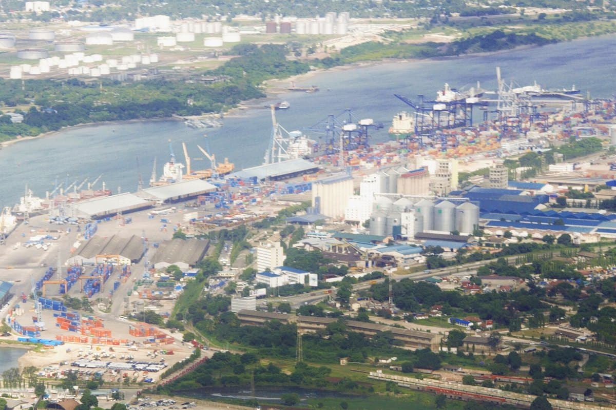 Container operations at a Tanzanian port, gantry cranes working over a berthed vessel