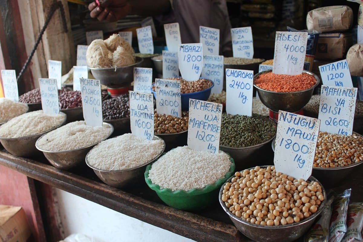 Assorted beans, grams and peas presented in separate labelled trays against a plain background