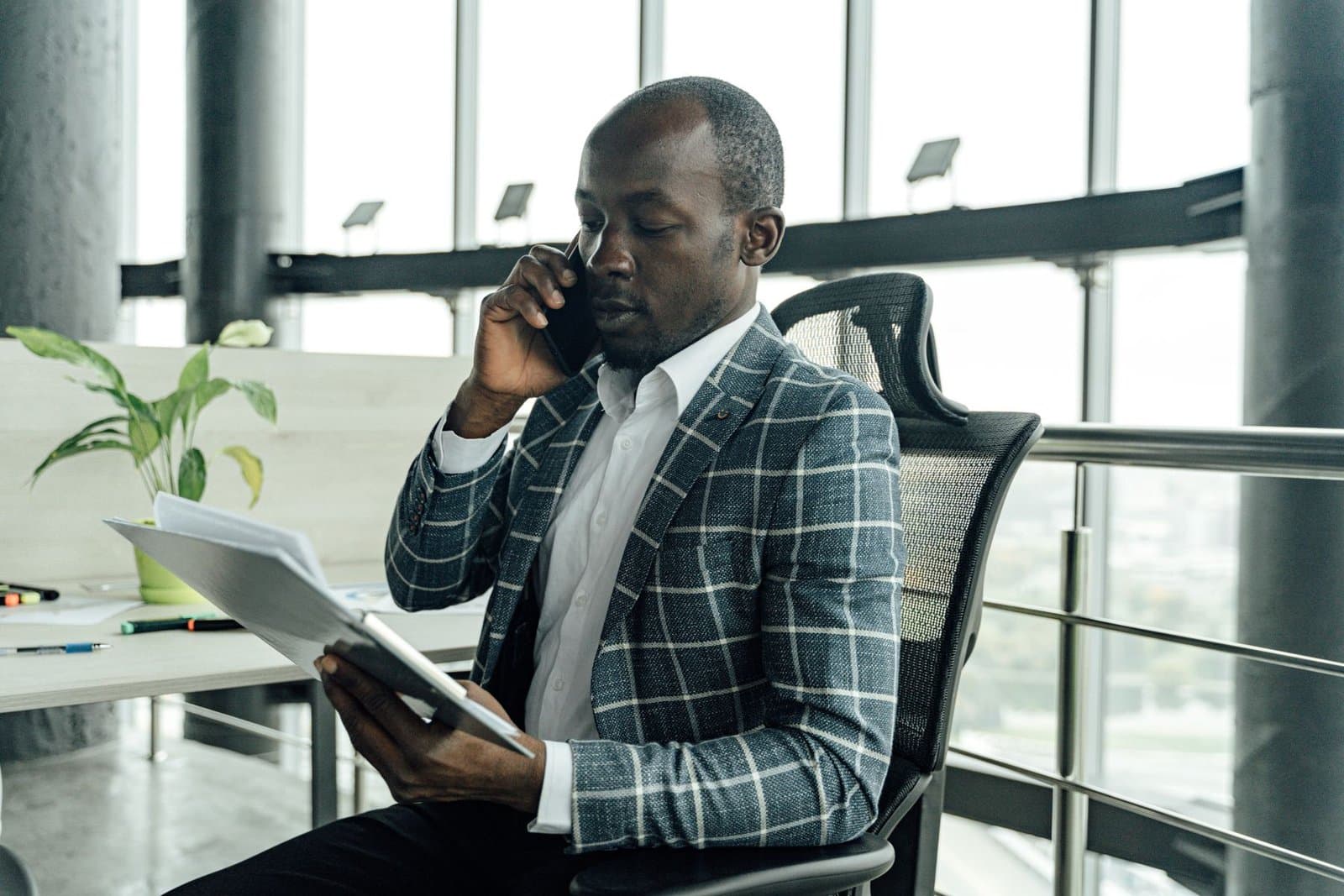 Sales team member handling a buyer enquiry at a desk in the sales office