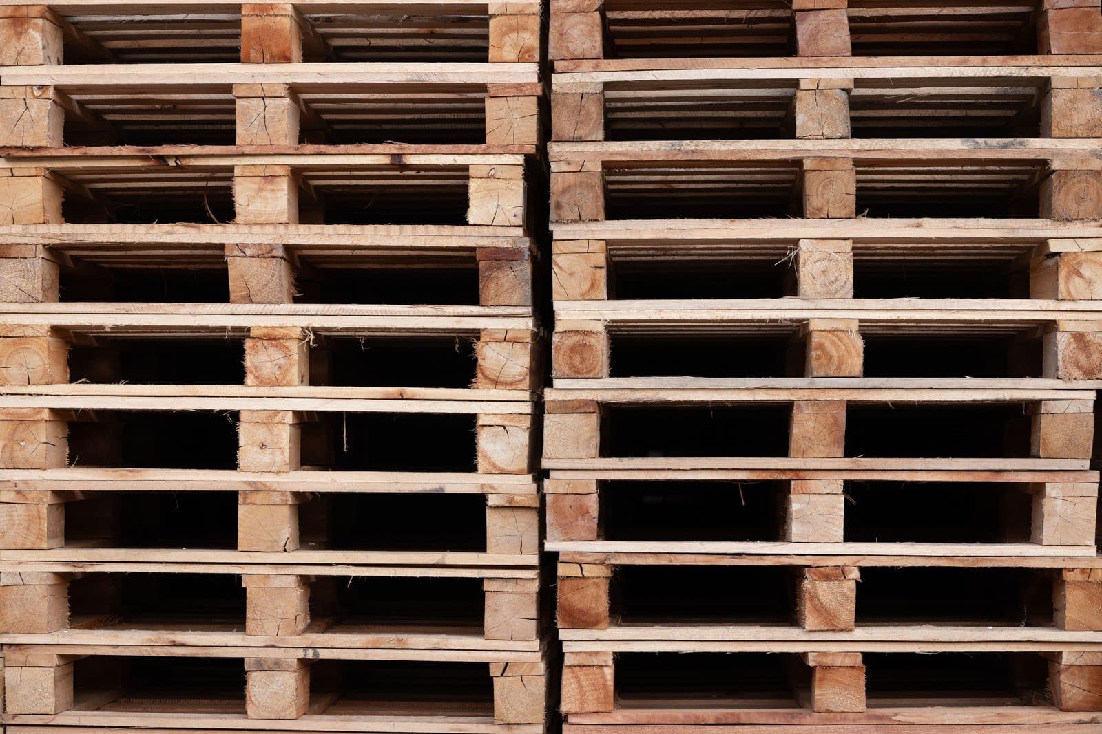 Wooden export pallets stacked in the yard, held ready for palletised consignments
