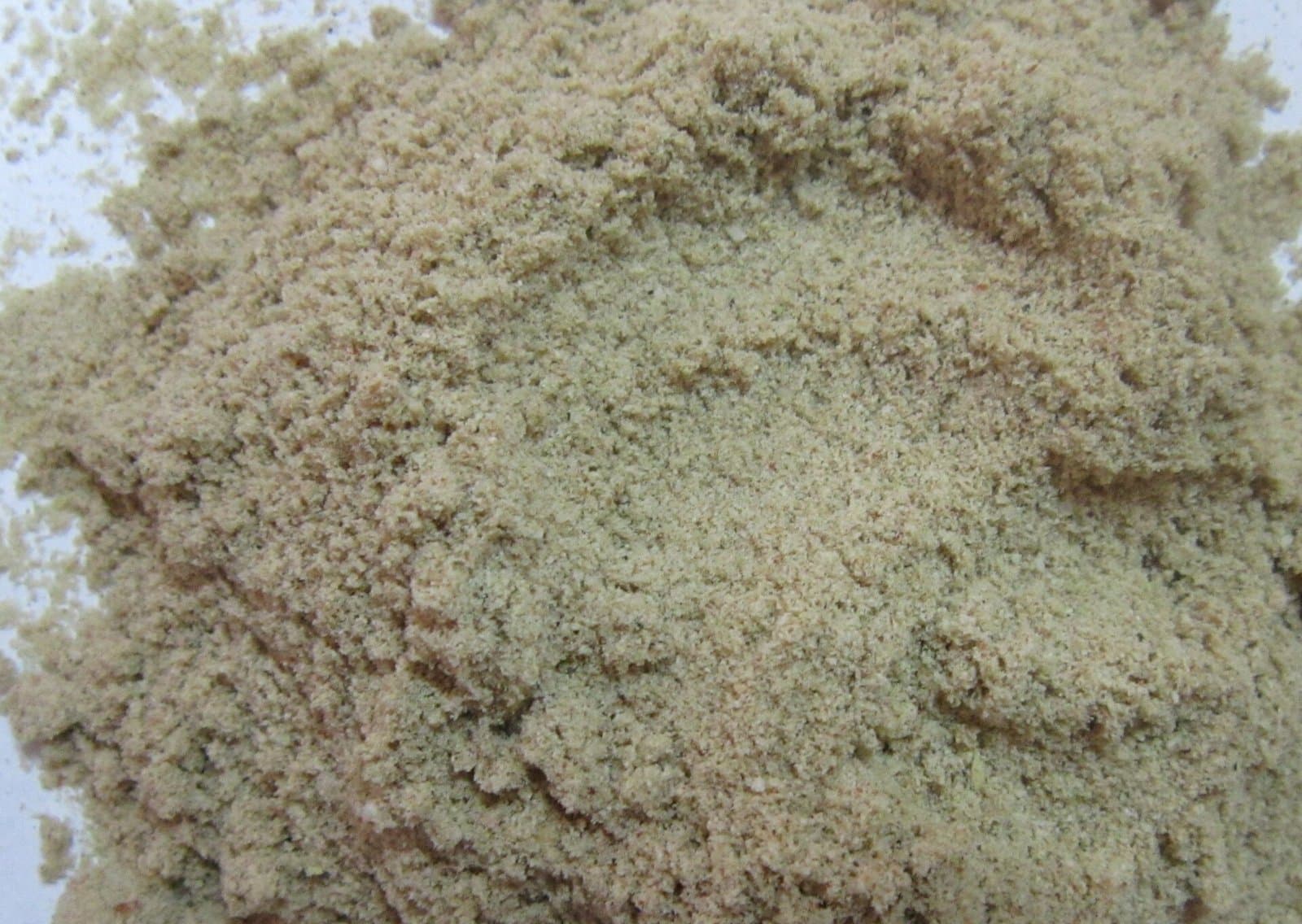 Fresh rice bran discharging from a mill outlet into a bulk bag